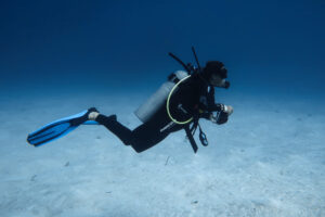 Scuba diver exploring the reef at Takata Experience in Mahahual. Beginner diving destinations